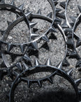 Metal spiked bangles on a textured surface